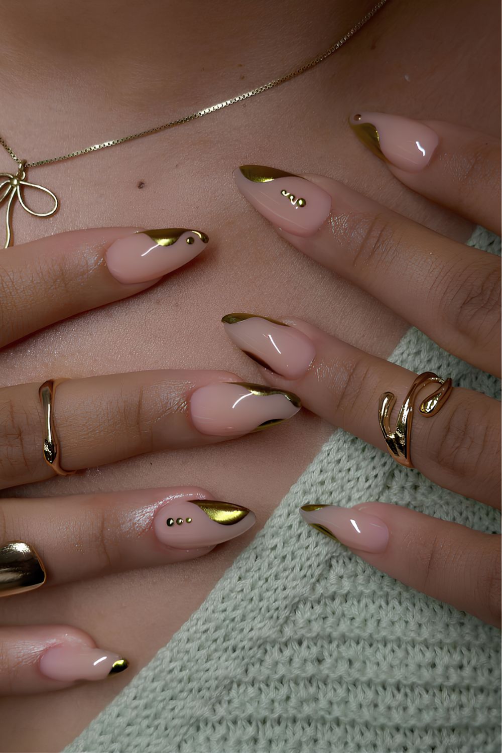 Abstract gold French nails with dot accents