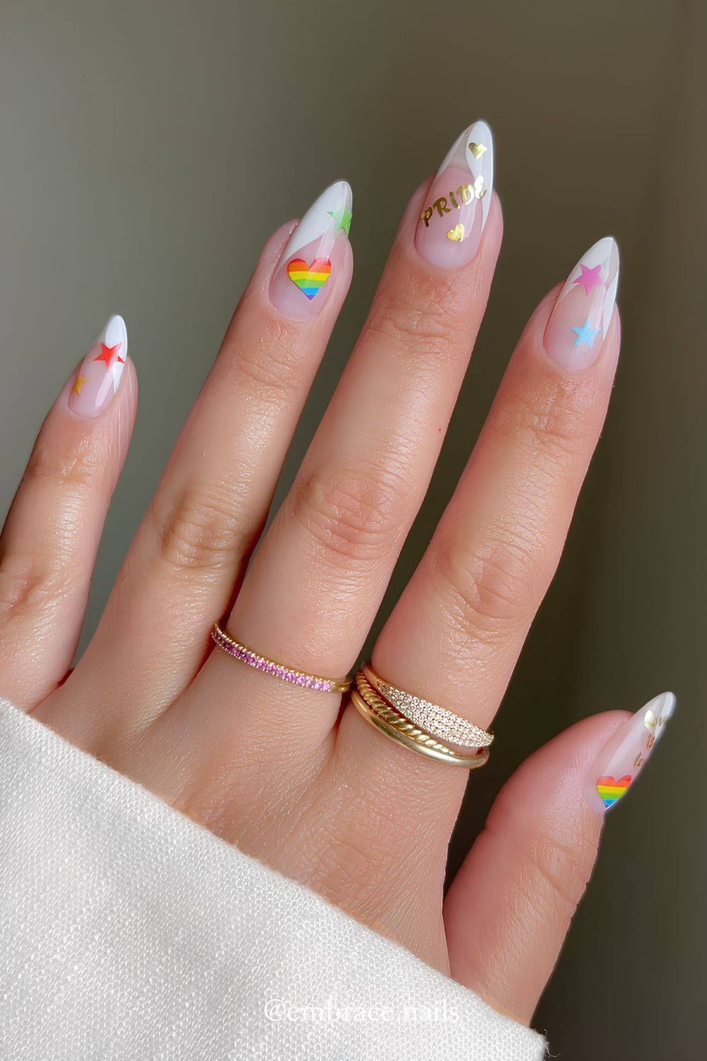Abstract white French nails with heart and star design and gold chrome pride typography
