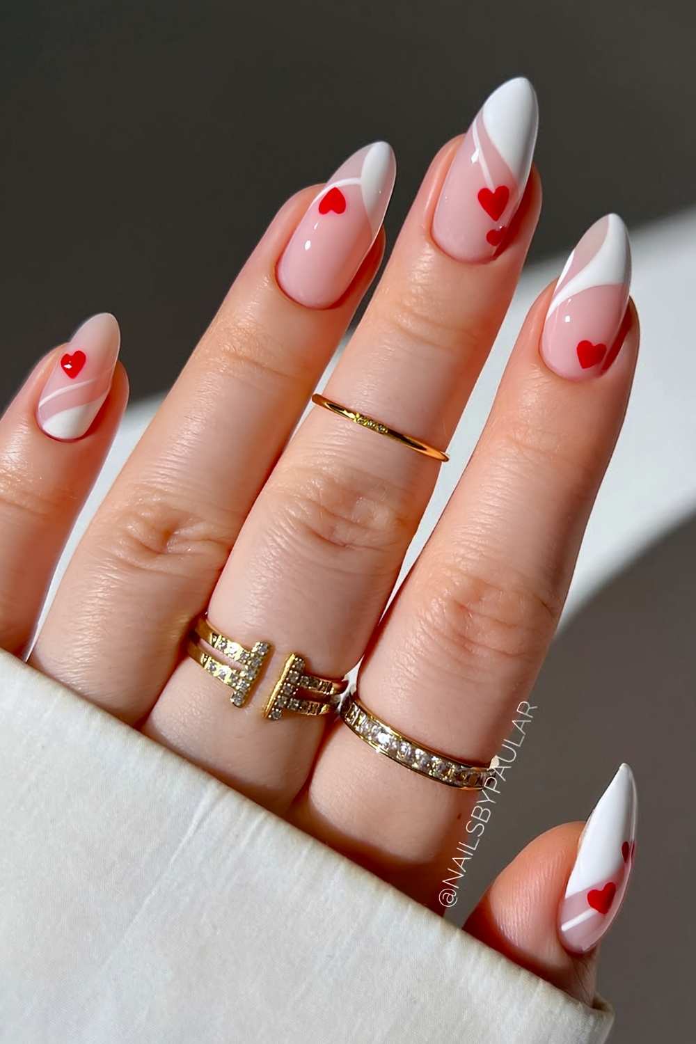 Abstract white French nails with red hearts