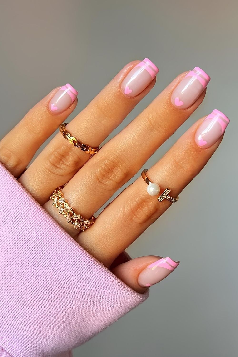 Baby pink double French nails with heart accents