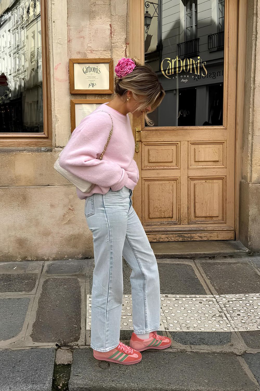 Baby pink sweater paired with jeans and pink sneakers
