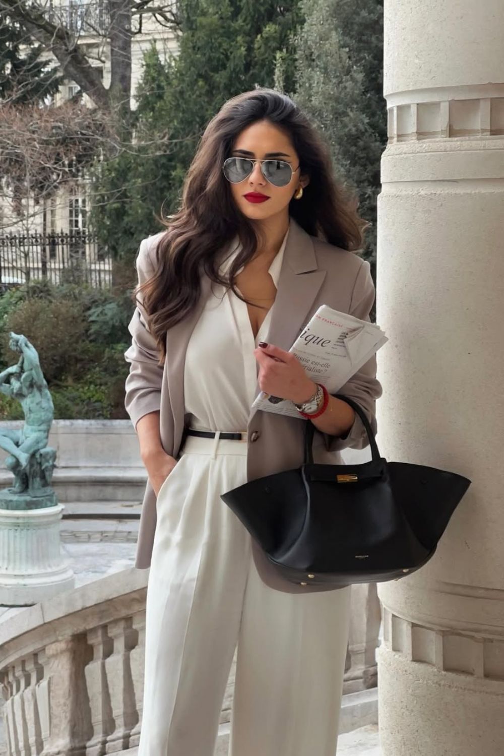 Beige blazer with white blouse and pleated trousers