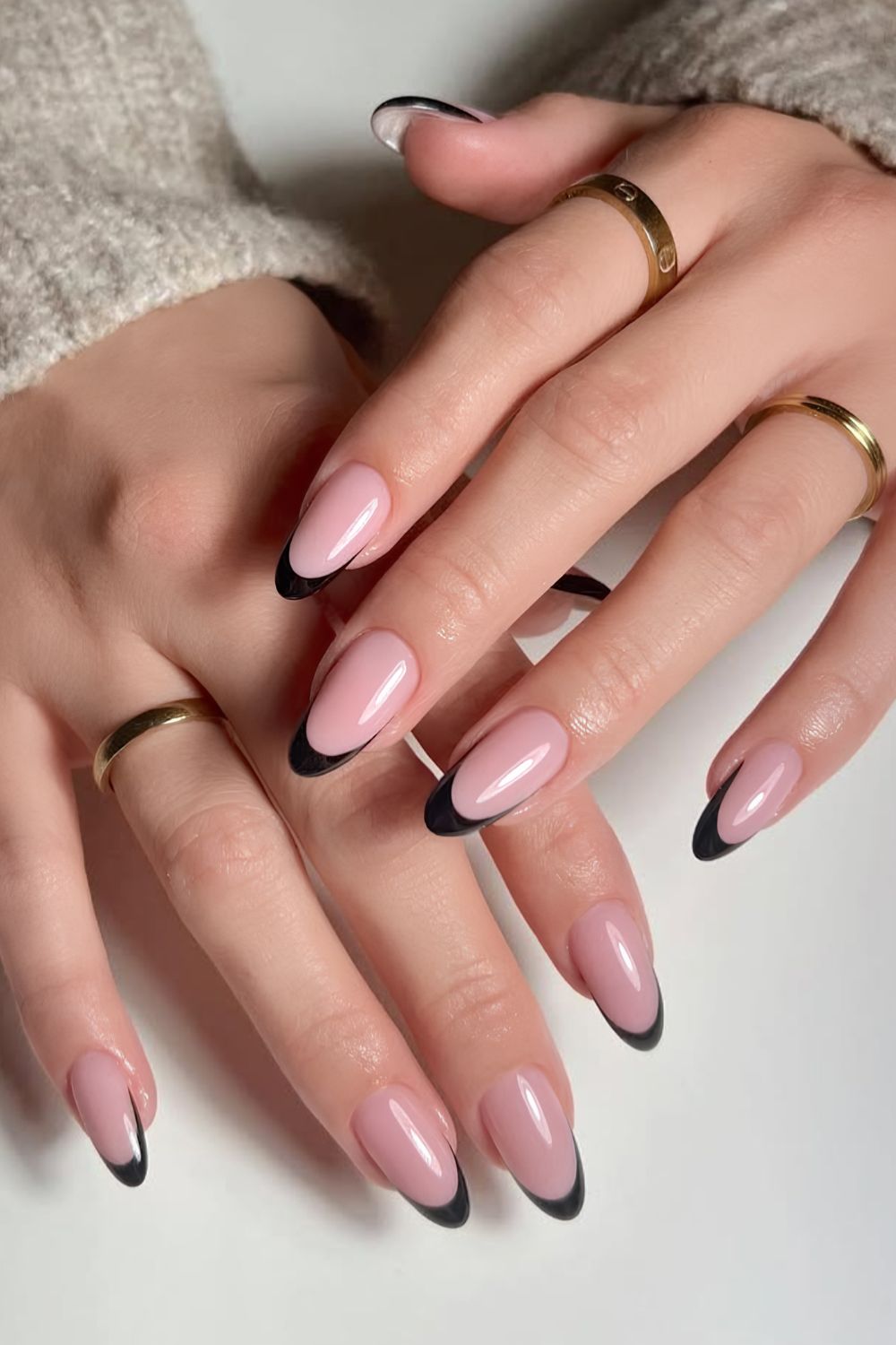 Black French nails on a milky base