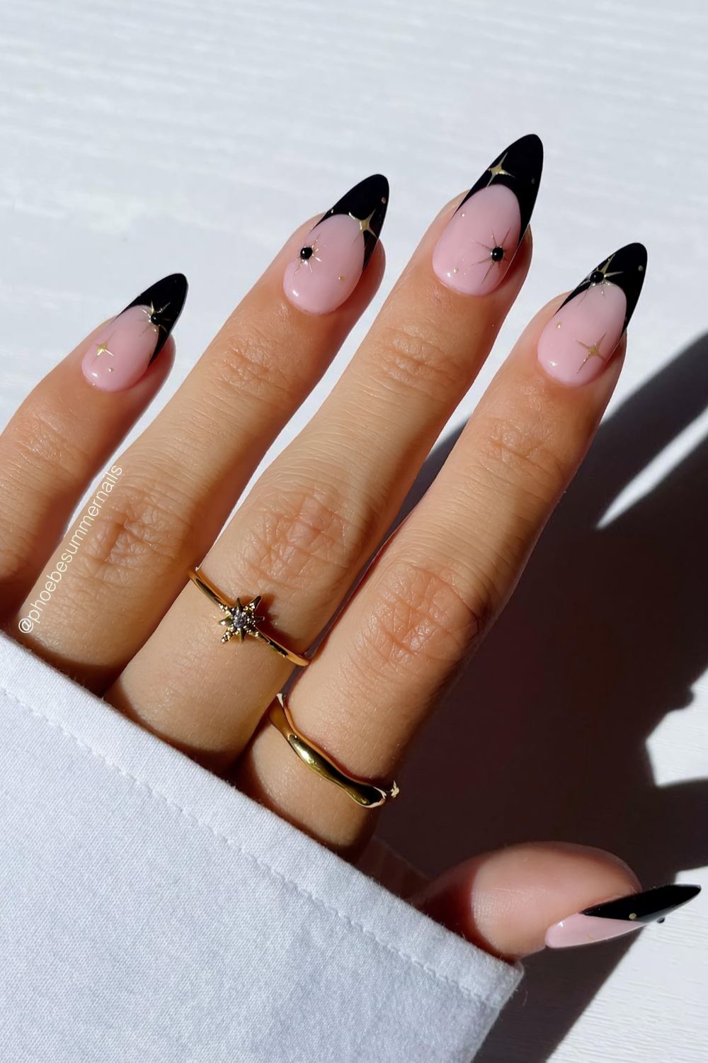Black French nails with celestial charms