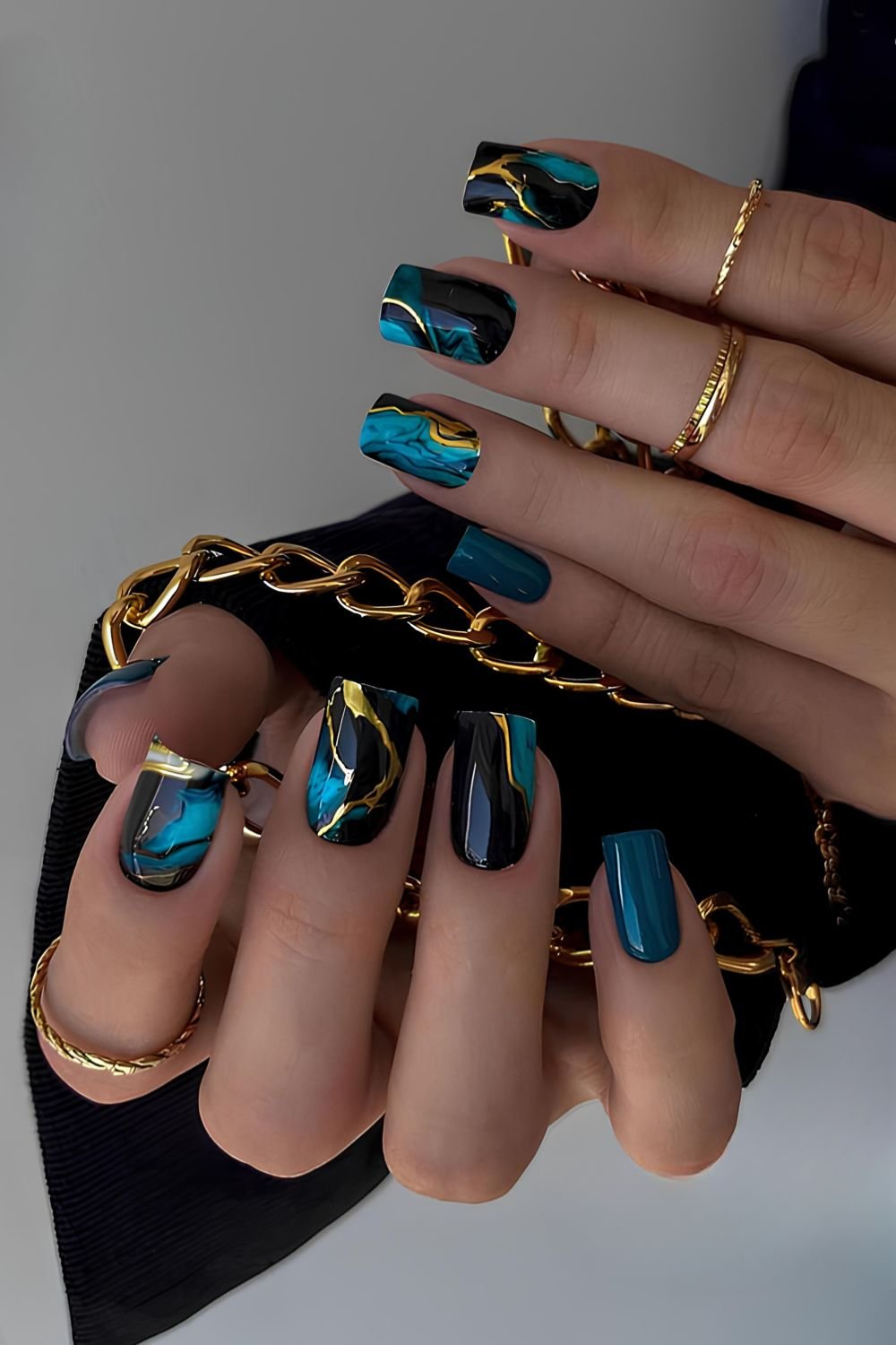 Black and blue marble nails with gold accents