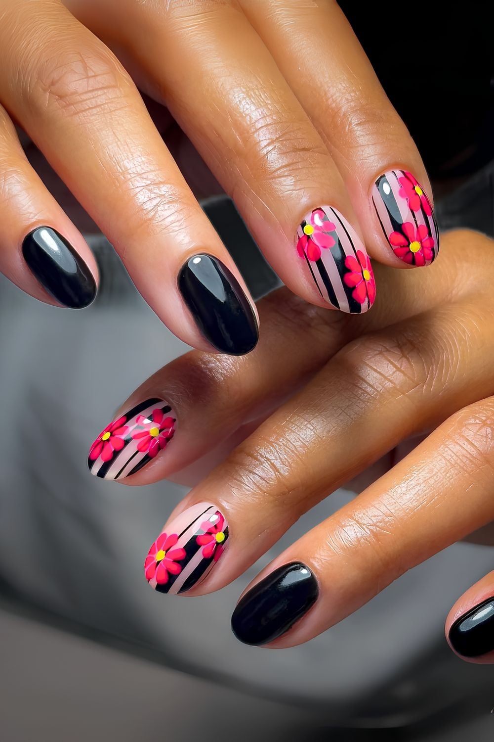 Black and neutral nails with black stripes and pink florals