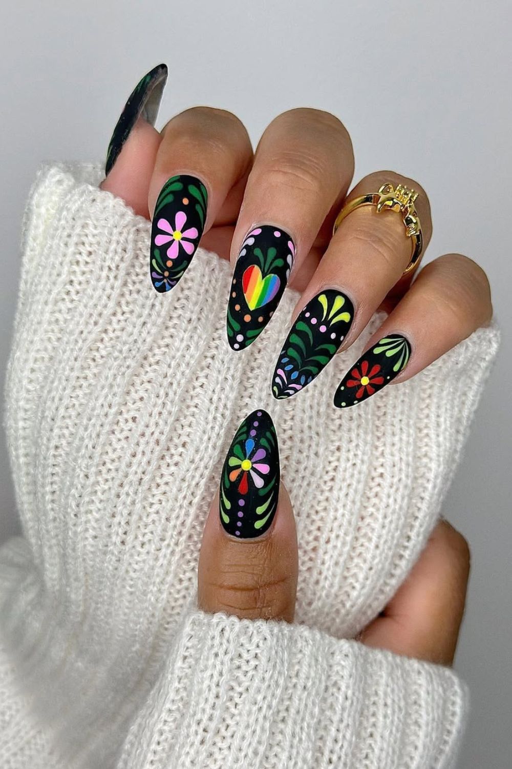 Black base nails with floral and pride motives