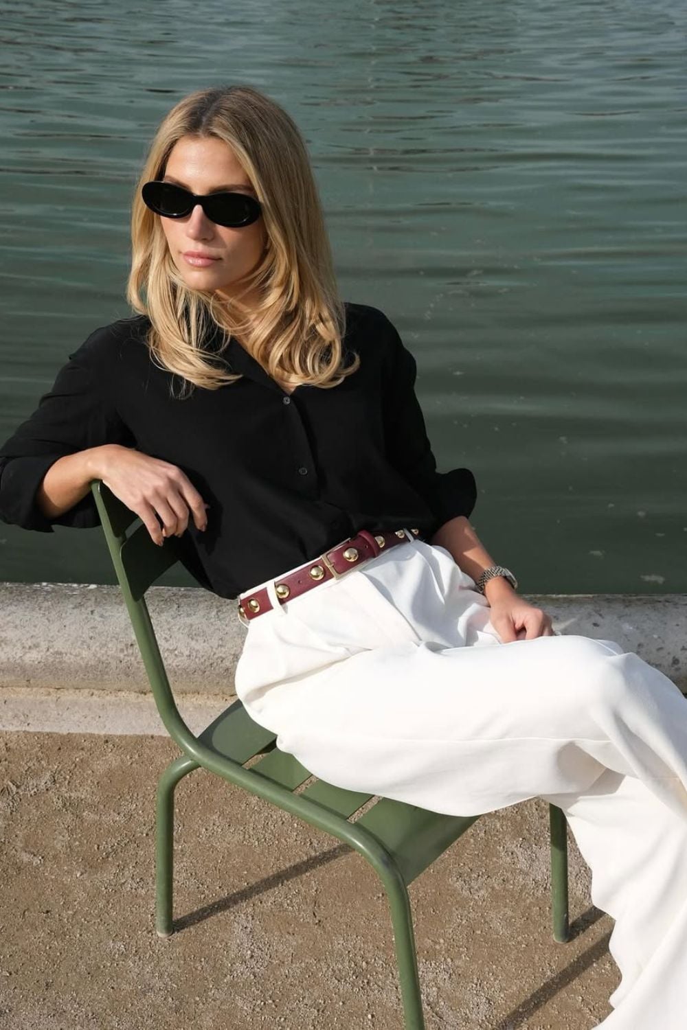 Black blouse with white trousers and burgundy belt