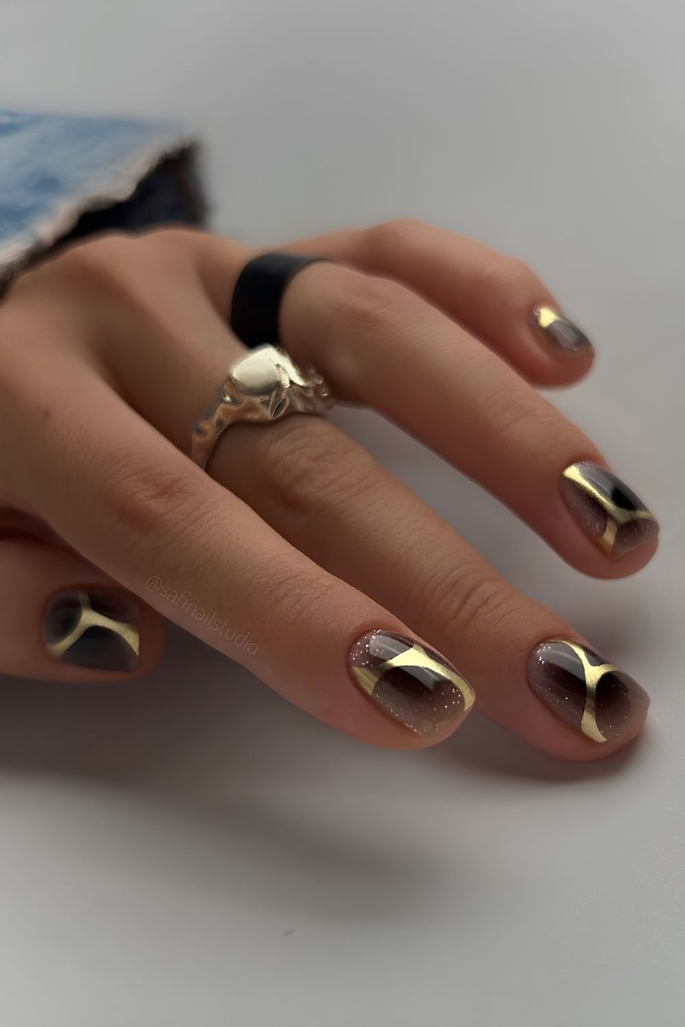 Black mani with abstract gold accent