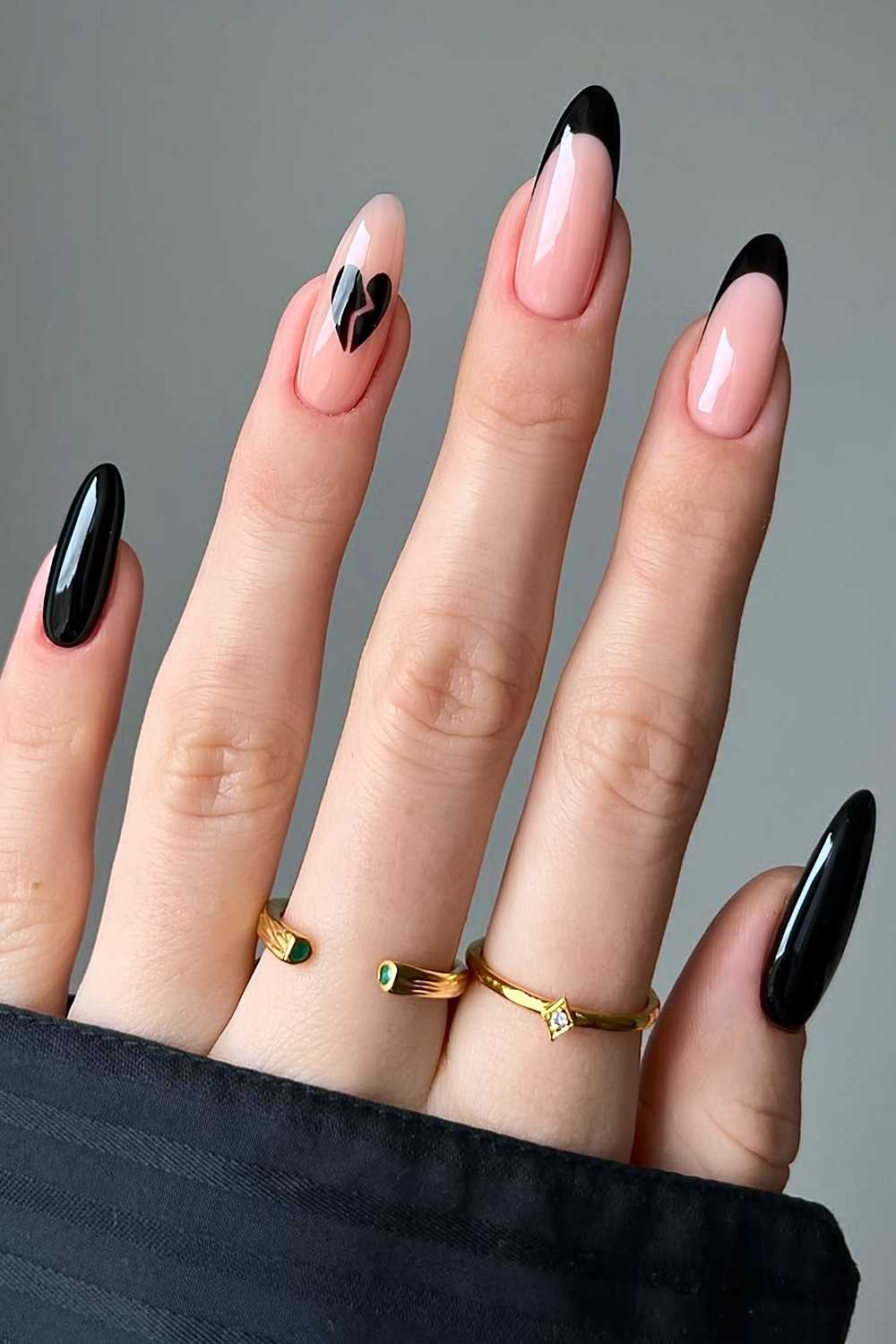 Black manicure with broken heart art