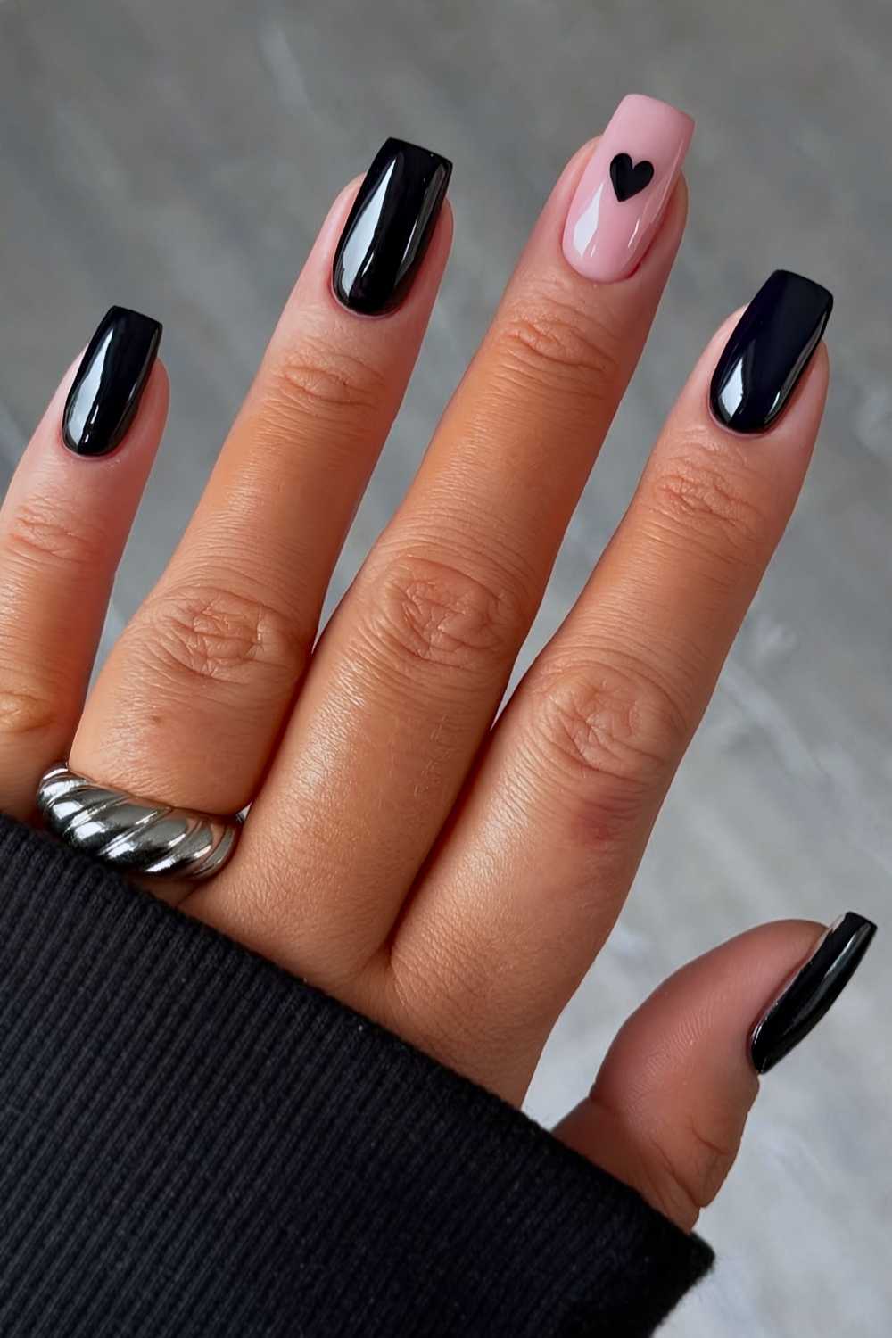 Black manicure with minimalist heart art
