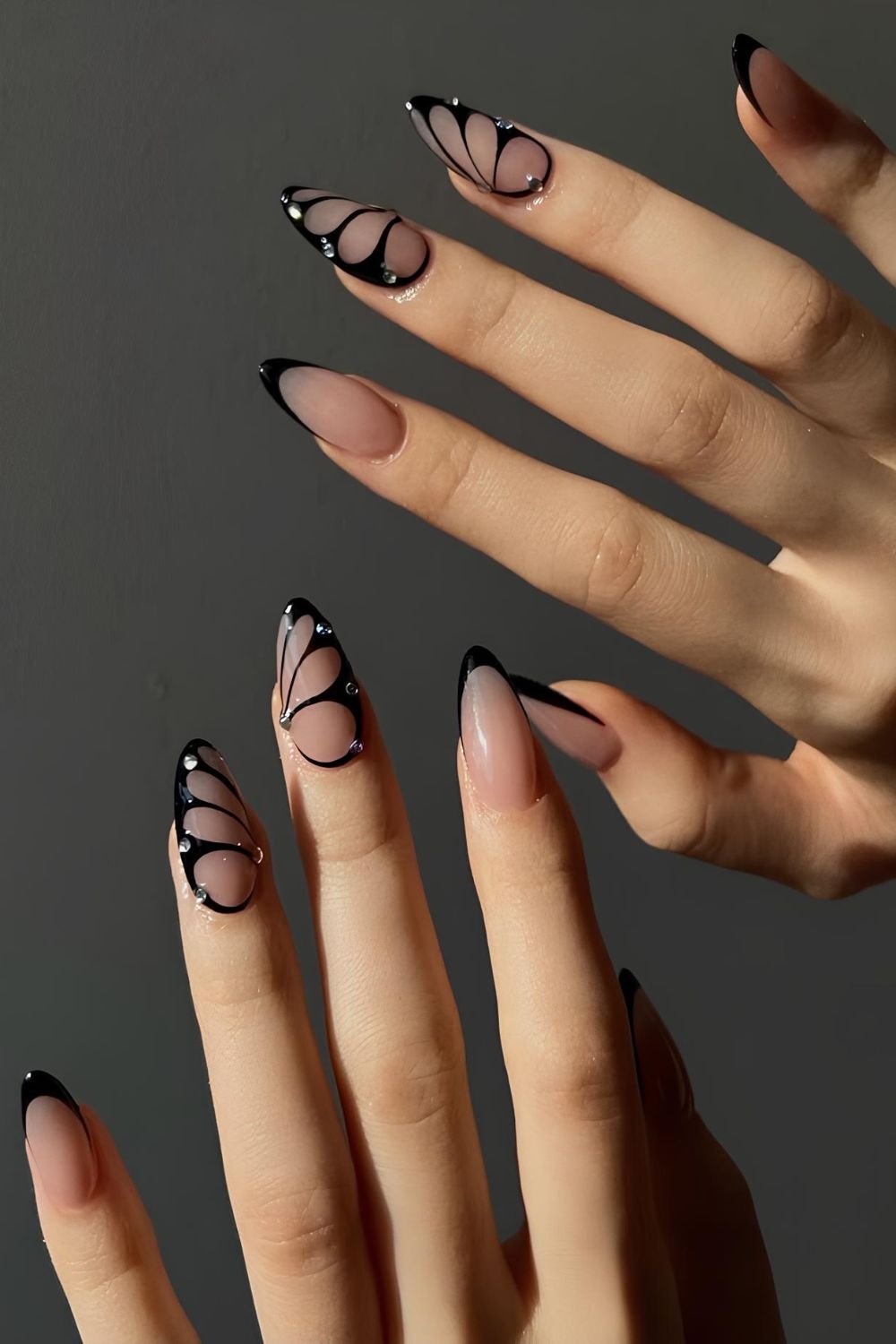 Black nails with butterfly design and rhinestones