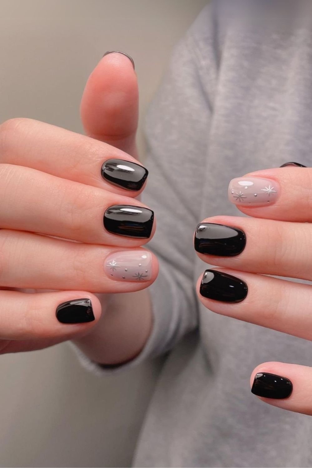 Black nails with chrome star accents