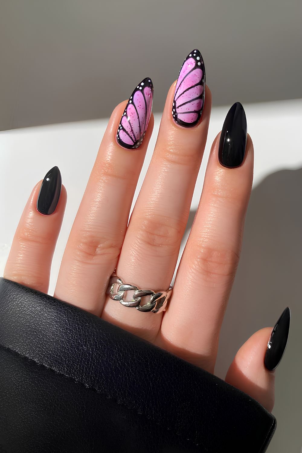 Black nails with pink butterfly art
