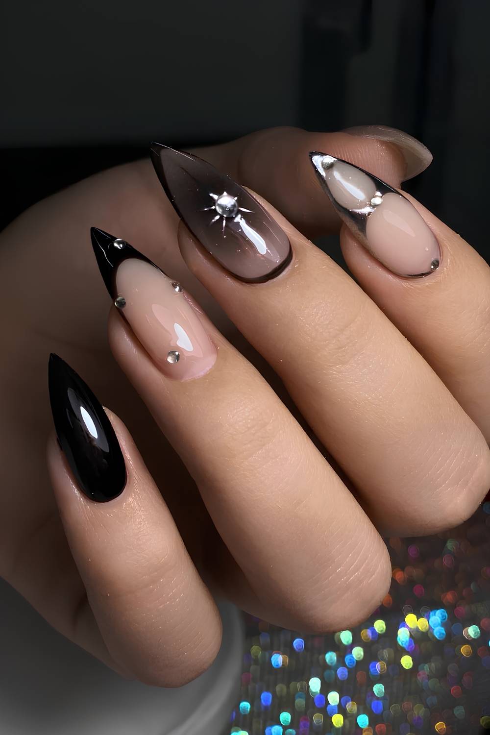 Black nails with silver chrome and gem accents