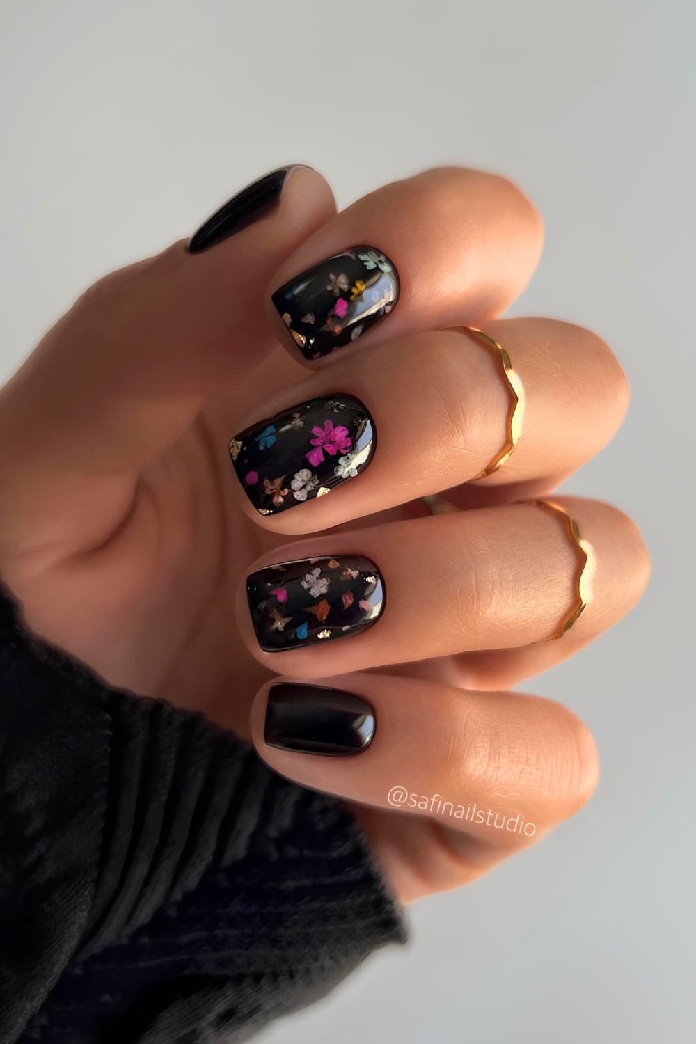 Black nails with tiny colorful flowers