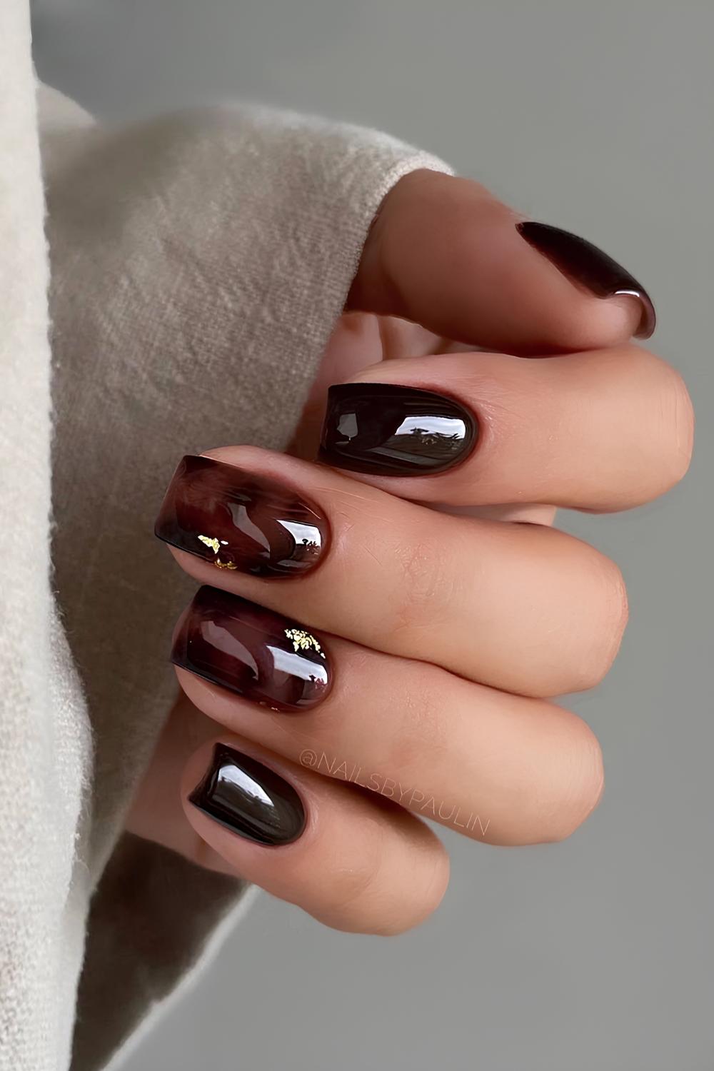 Black nails with tortoise shell and gold accents