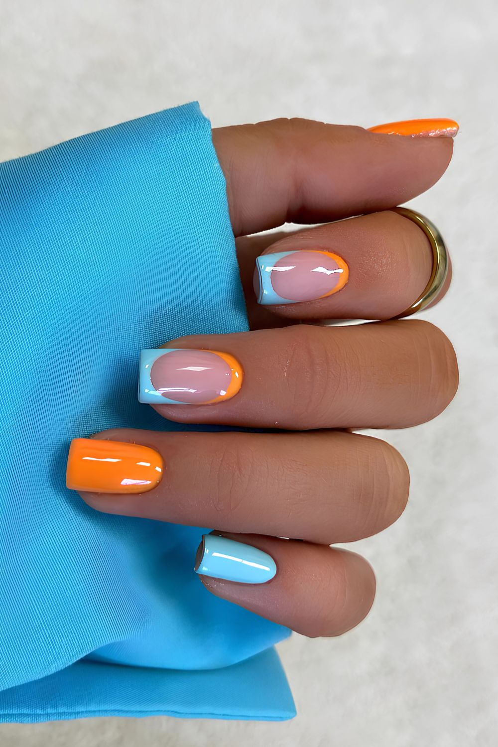 Blue and orange nails with negative space design