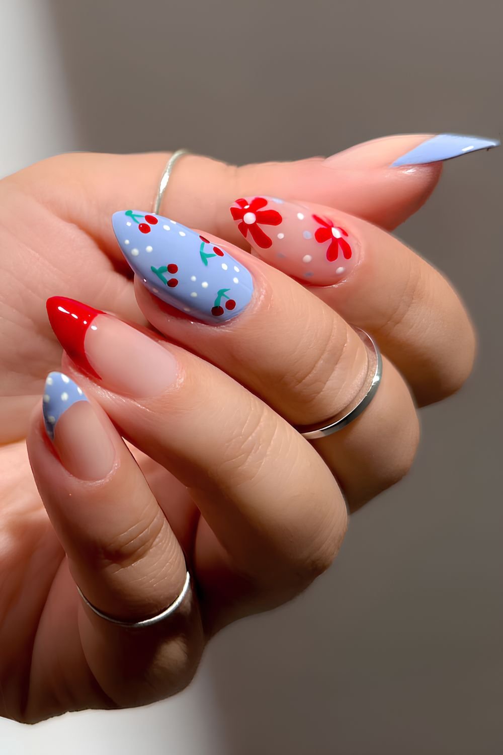 Blue and red nails with cherries and flowers
