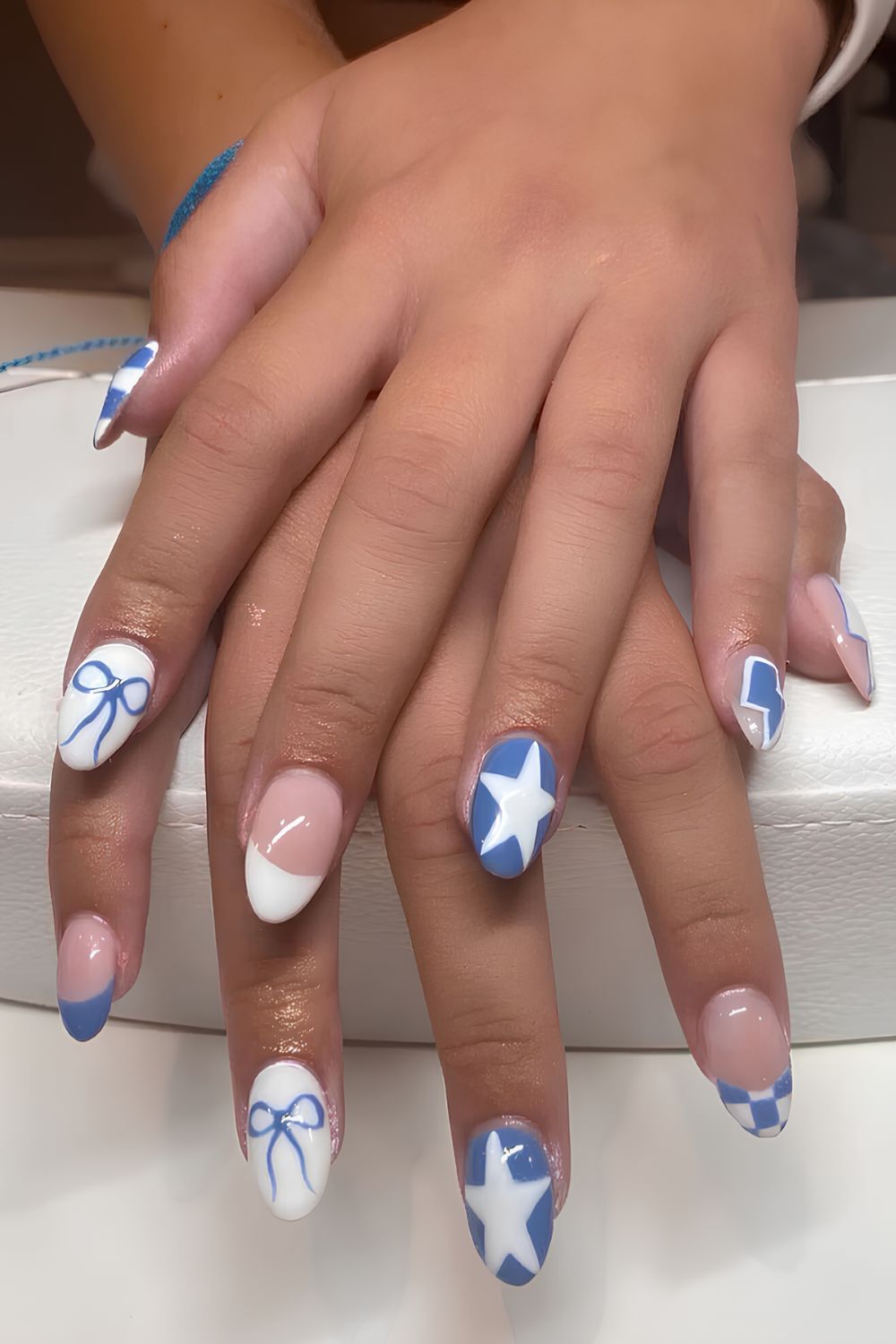 Blue and white nails with ribbons and stars