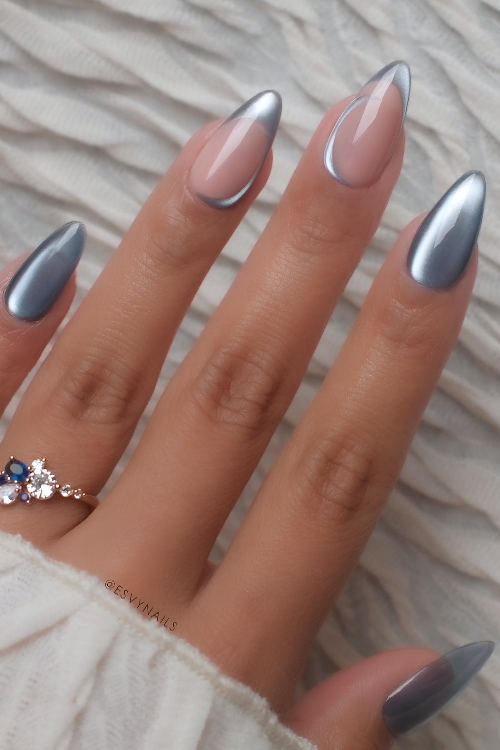 Blue cat eye nails with accent French tips and swirls