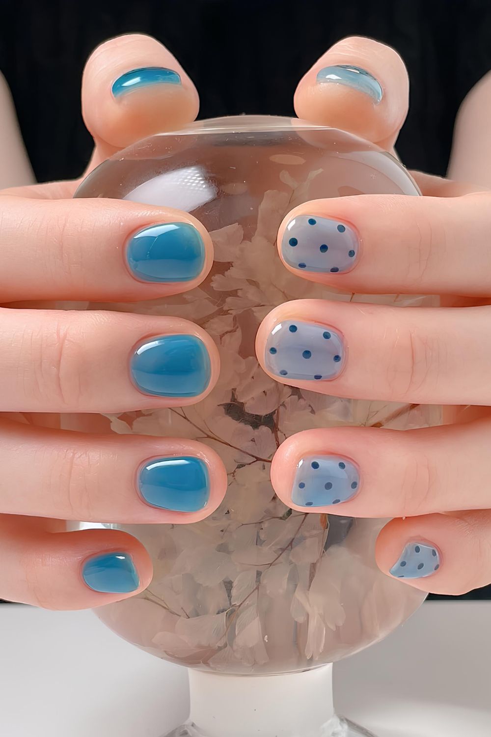 Blue jelly nails with navy blue polka dots