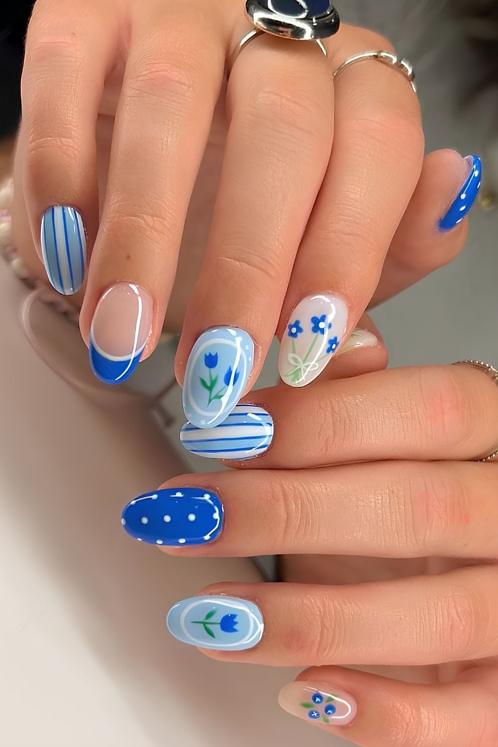 Blue mix and match nails with florals and blueberries