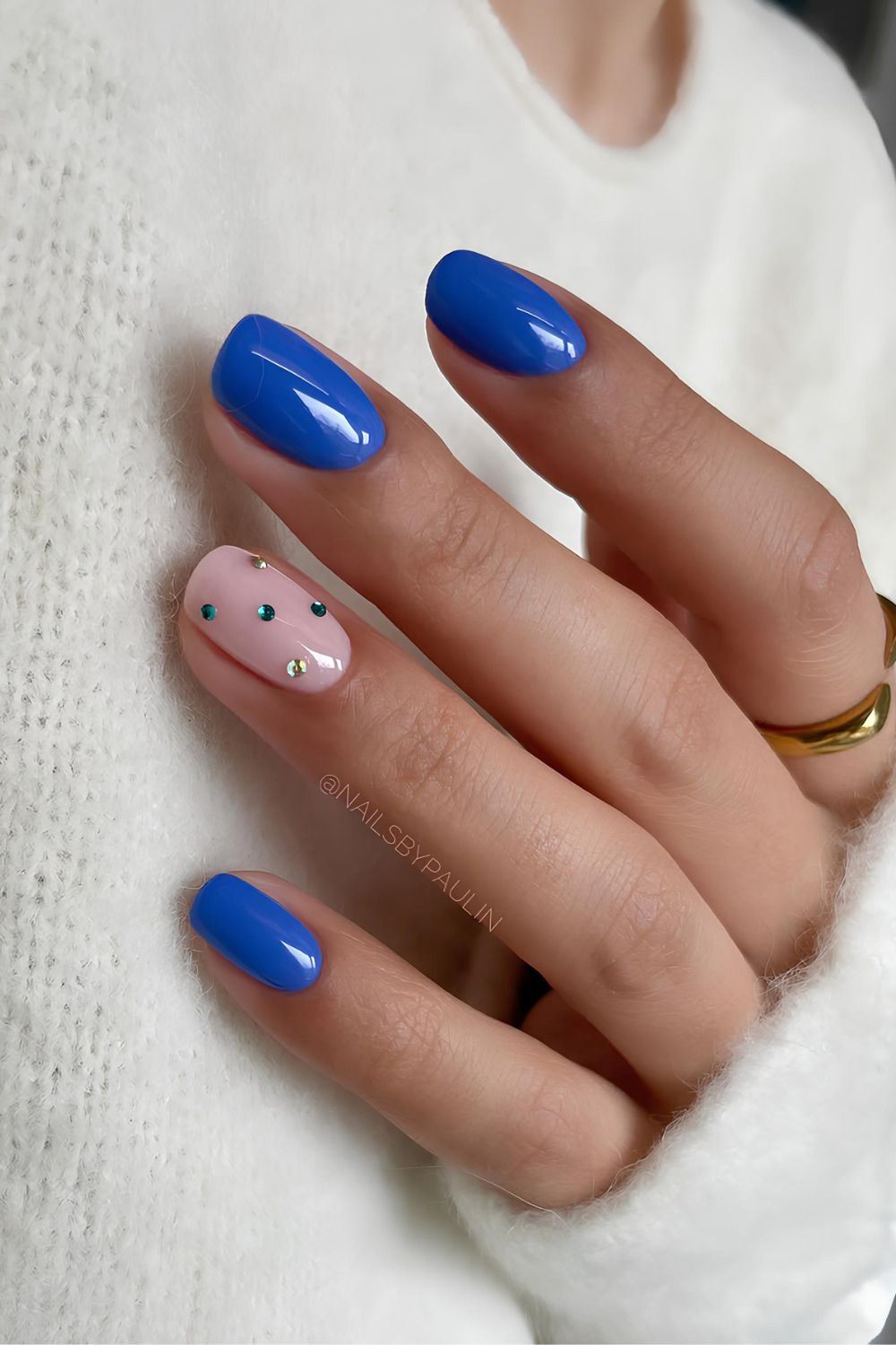 Blue nails with rhinestone accents