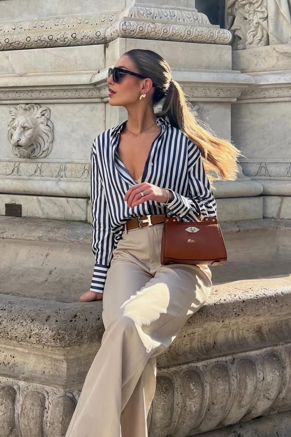 Blue striped shirt with beige trousers and brown accessories