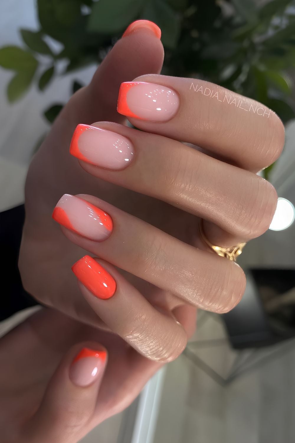 Bright orange nails with negative space accent