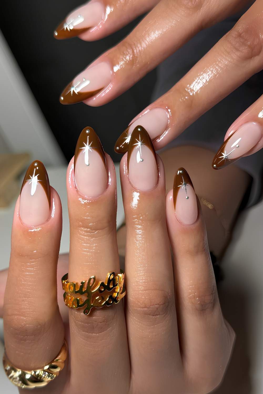Brown French tip mani with gold chrome stars