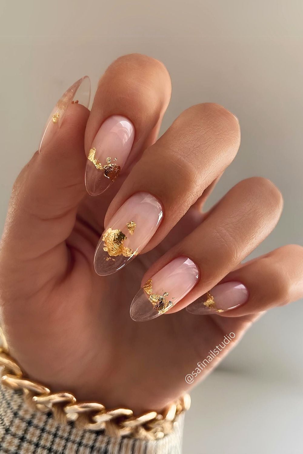 Brown French tip nails with gold foil accents