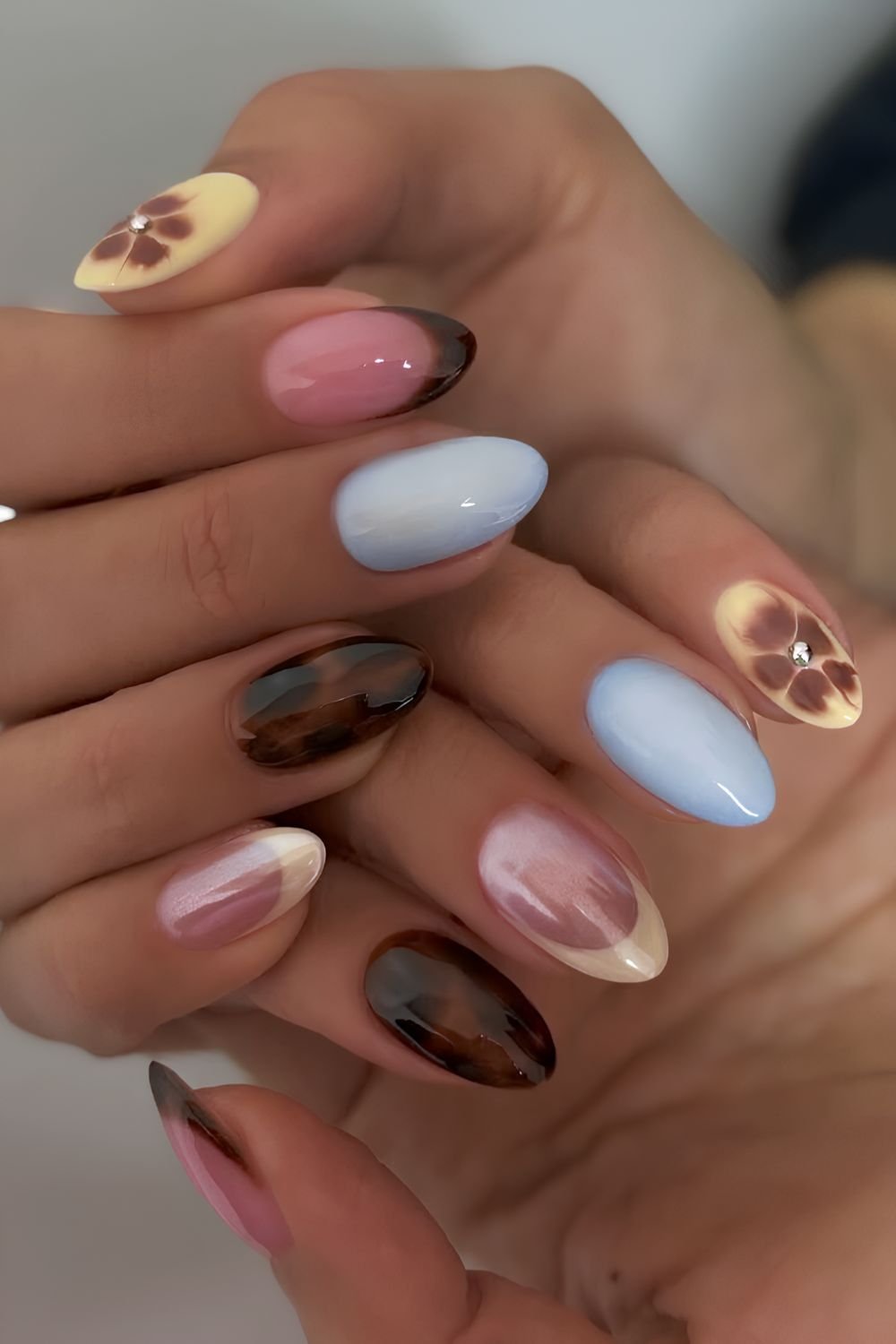 Brown and blue nails with tortie and blooming gel accents