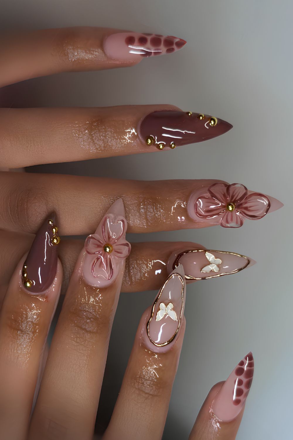 Brown nails with sculpted florals and butterflies