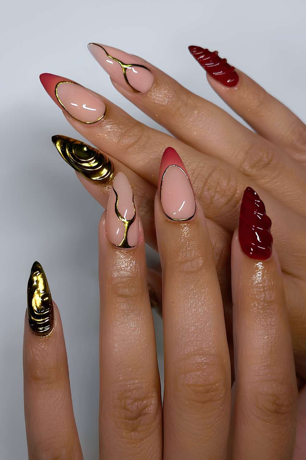 Burgundy and orange nails with gold accents