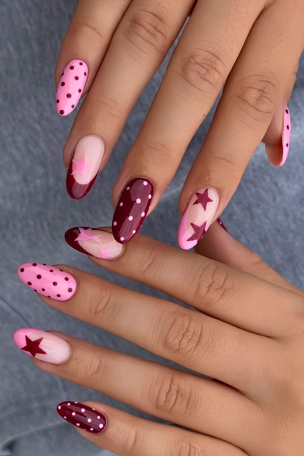 Burgundy and pink nails with stars and polka dots