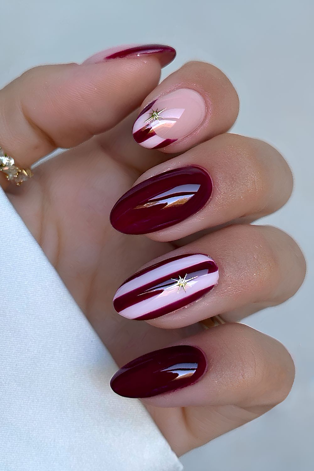 Burgundy and white Christmas nails with stripe art