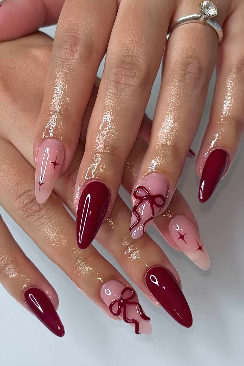 Burgundy nails with 3d bows and star art