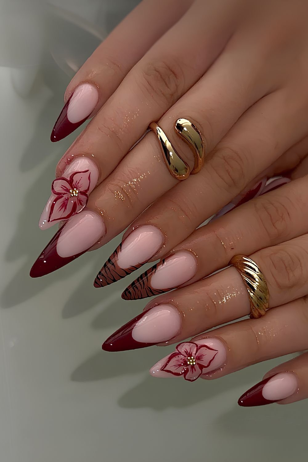 Burgundy nails with 3d flowers and animal print
