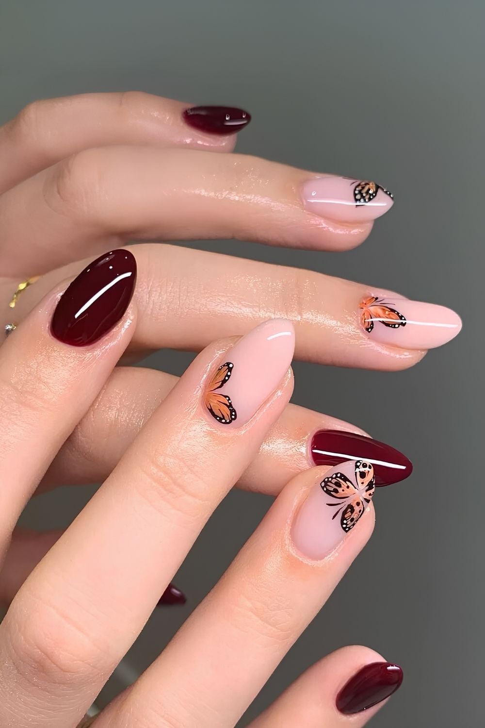 Burgundy nails with butterfly art