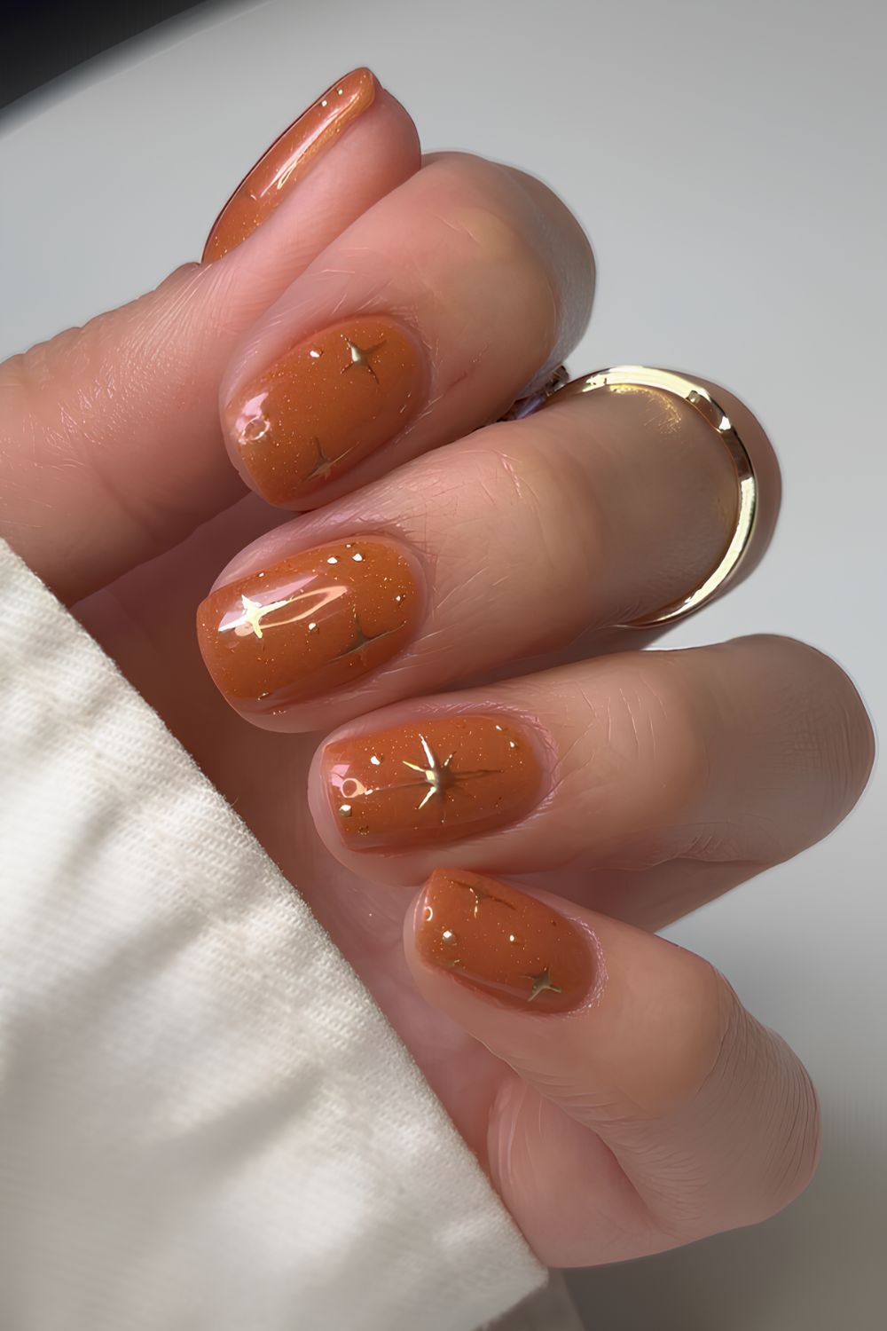 Burnt orange nails with chrome star art