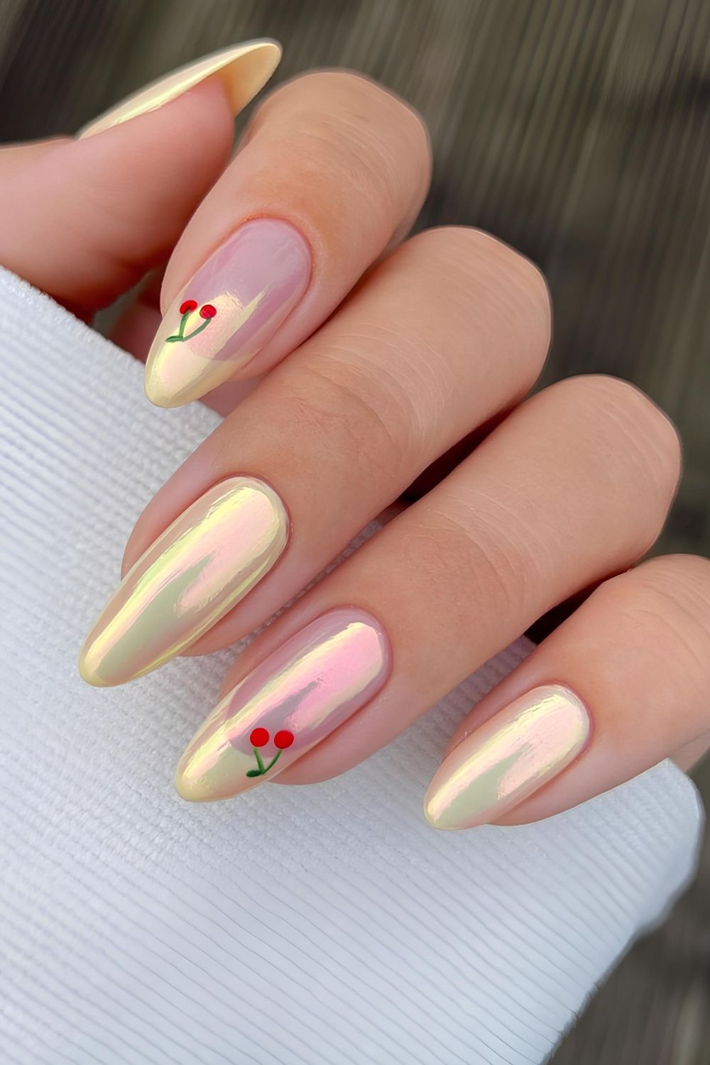 Butter yellow chrome nails with cherry accents