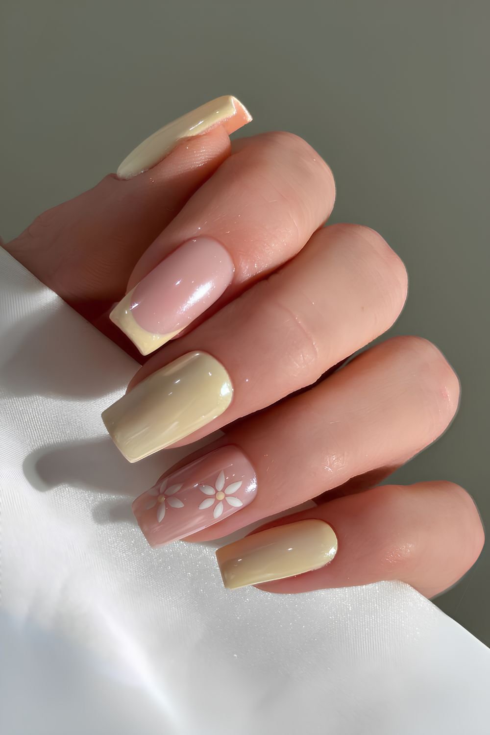 Butter yellow chrome nails with flowers