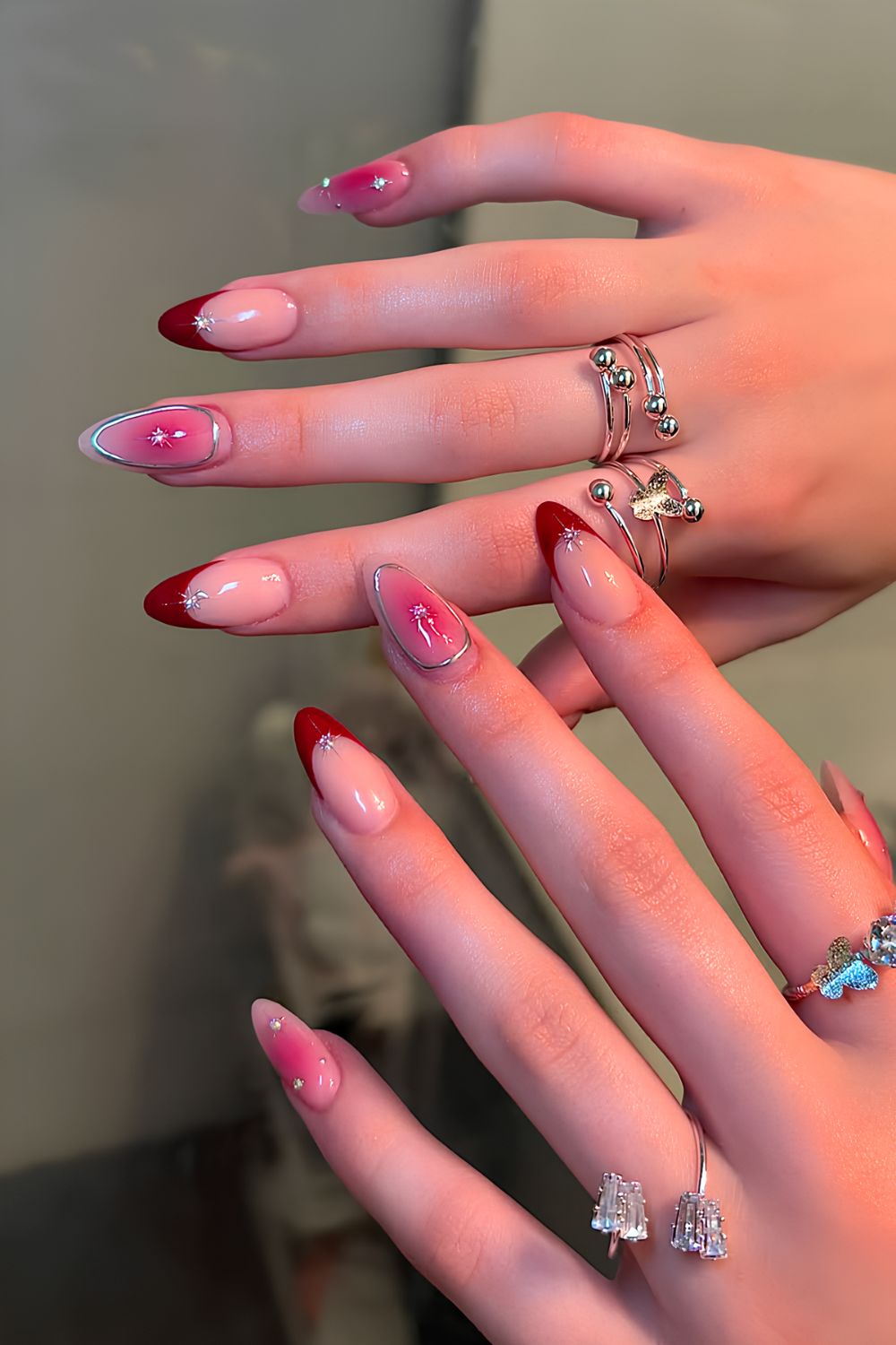 Cherry red French and aura nails with silver chrome details