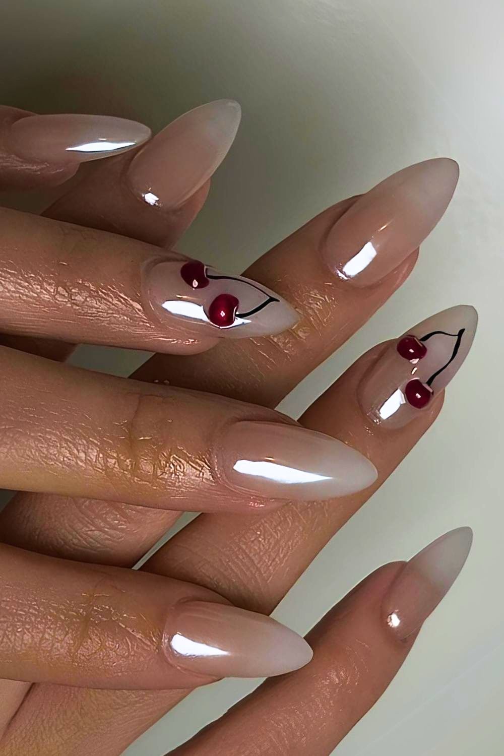 Chrome white nails with cherry accents
