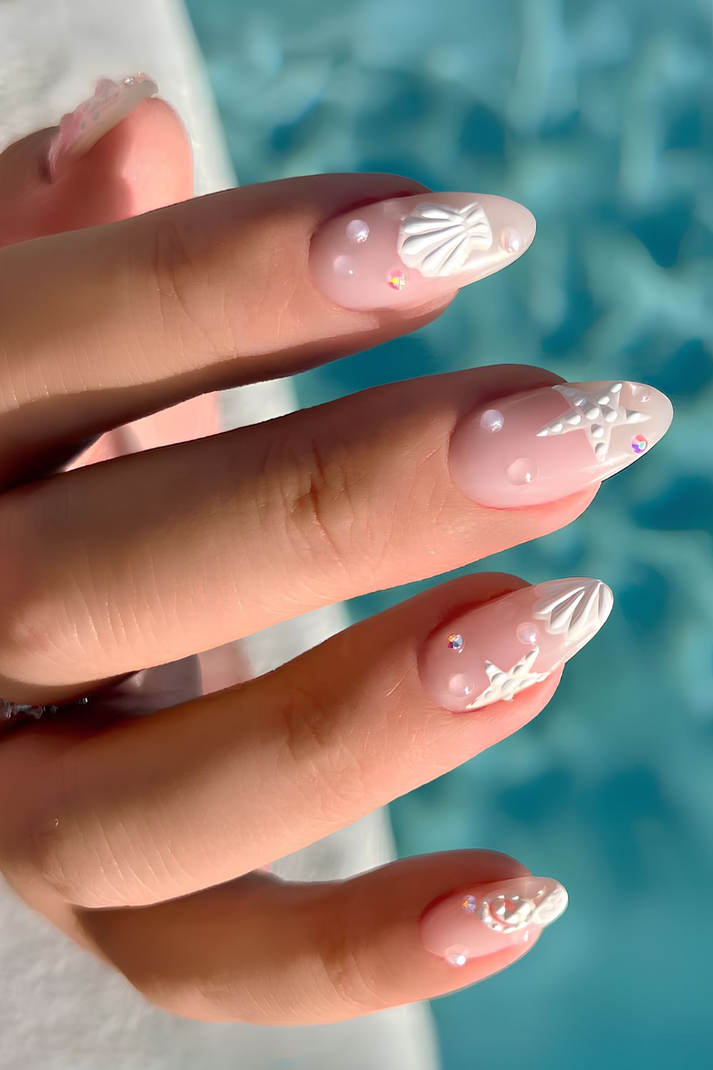 Clear nails with seashell and pearl accents