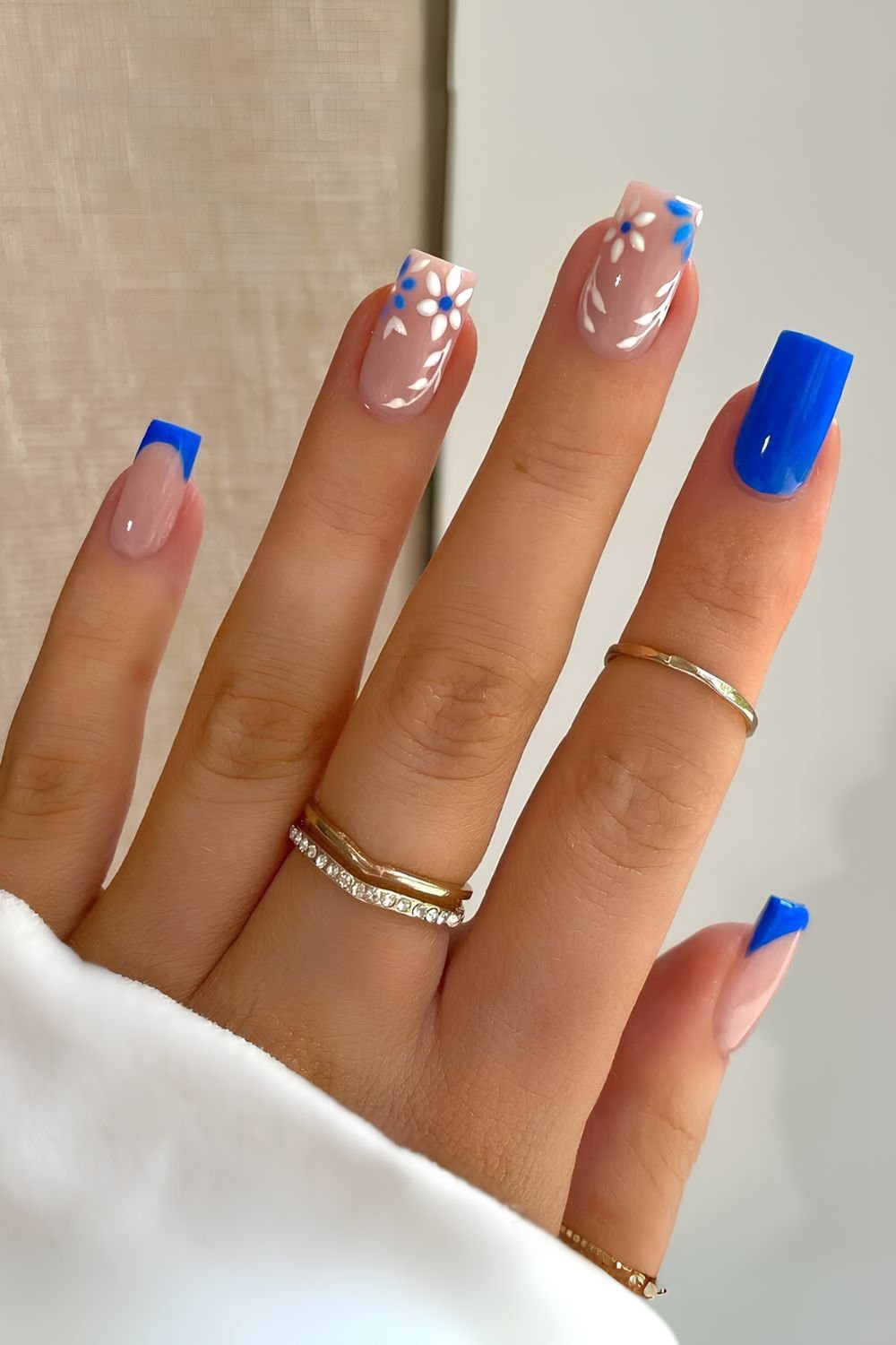 Cobalt blue nails with white floral accents