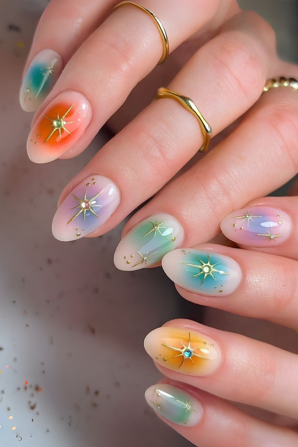 Colorful aura effect nails with gold chrome celestial accents
