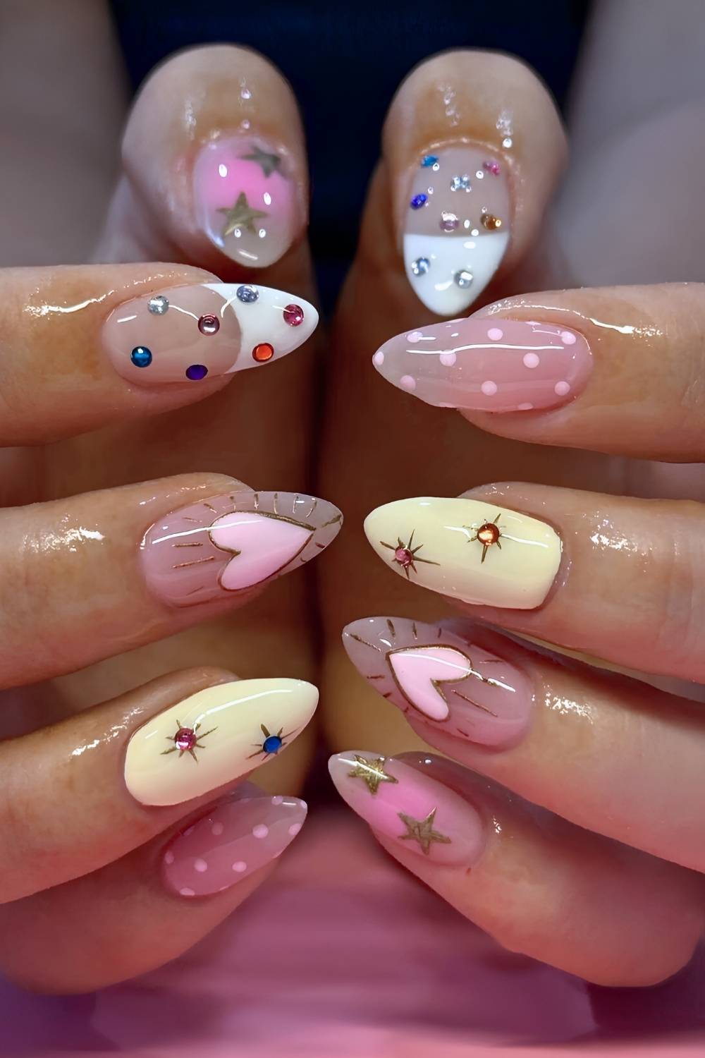 Colorful mix and match mani with hearts and gems