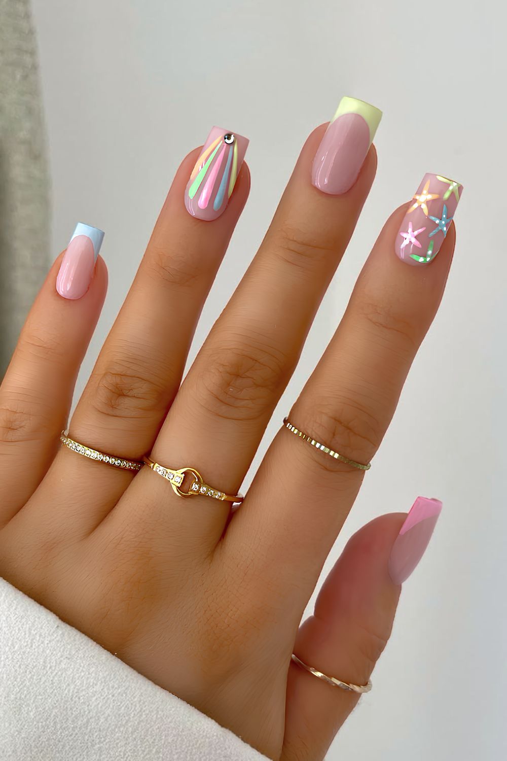 Colorful pastel French tips with rainbow and starfish accents